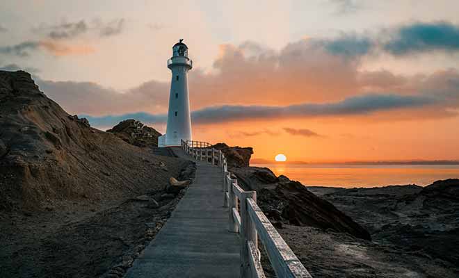 Le soleil se couche à l'horizon et fait rougeoyer le ciel et la mer.