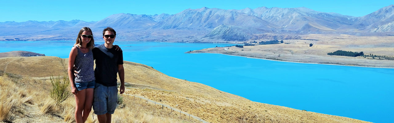 Julie and Quentin of VeryNZ Trip in front of the Tekapo lake.